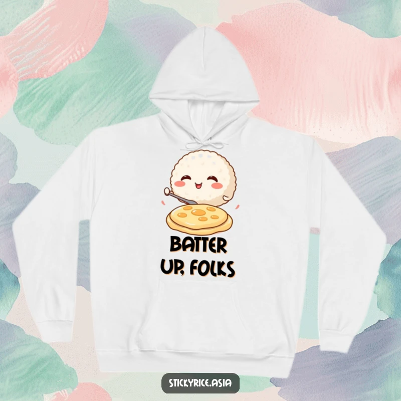 Funny Hoodie with a round, smiling rice ball character enthusiastically flipping a miniature pancake, radiating warmth and breakfast joy.